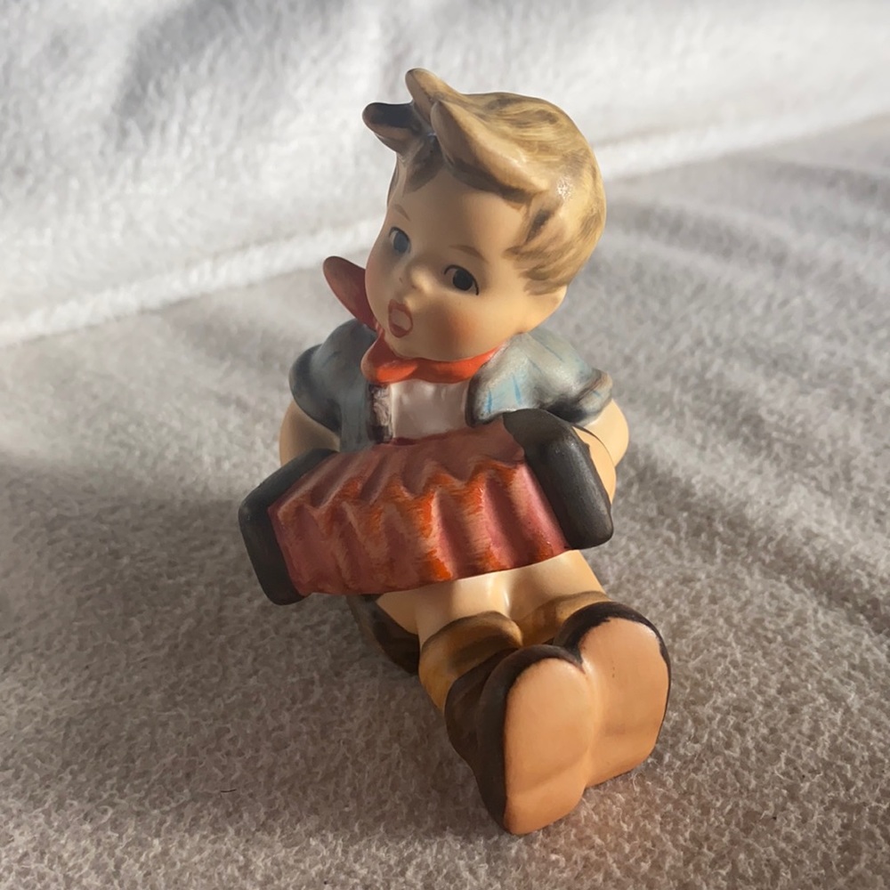 Hummel Figurine #390 “Boy with Accordion” Boy seated with instrument